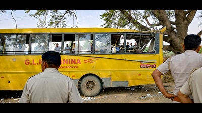 Locals near a damaged school bus after an accident near Mahendragarh in Narnaul district, Haryana on Thursday. (PTI)