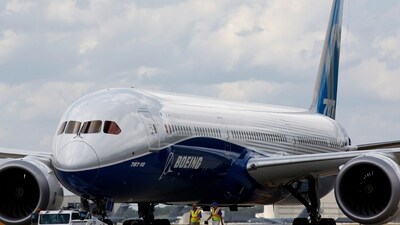 Boeing employees walk the new Boeing 787-10 Dreamliner down towards the delivery ramp area at the company's facility. (AP) Boeing employees walk the new Boeing 787-10 Dreamliner down towards the delivery ramp area at the company's facility. (AP)