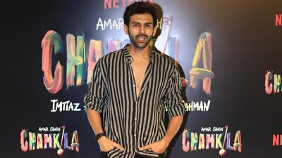 Triptii Dimri's Bhool Bhulaiyaa 3 co-star Kartik Aaryan was also seen at the Amar Singh Chamkila screening. The actor wore a grey and black striped shirt with black pants. He too posed solo for paparazzi. 