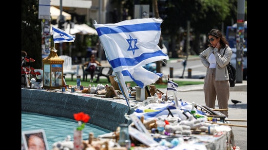 A woman looks at memorabilia and pictures of the hostages kidnapped in the deadly October 7 attack on Israel by the Palestinian Islamist group Hamas from Gaza, at Dizengoff Square in Tel Aviv on April 11 (REUTERS)