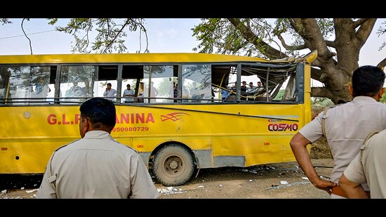 Locals near a damaged school bus after an accident near Mahendragarh in Narnaul district, Haryana on Thursday. (PTI)