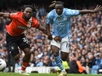 Luton Town's Fred Onyedinma, left, challenges for the ball with Manchester City's Jeremy Doku during the match between Manchester City and Luton Town at Etihad stadium in Manchester. Luton Town's Fred Onyedinma, left, challenges for the ball with Manchester City's Jeremy Doku during the match between Manchester City and Luton Town at Etihad stadium in Manchester.