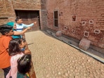 Visitors look at a wall with bullet marks during their visit to the Jallianwala Bagh Martyrs' Memorial on the eve of the Jallianwala Bagh massacre anniversary, in Amritsar Visitors look at a wall with bullet marks during their visit to the Jallianwala Bagh Martyrs' Memorial on the eve of the Jallianwala Bagh massacre anniversary, in Amritsar