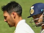 Virat Kohli (L) looks at Mitchell Johnson during the first Test of the series in 2014