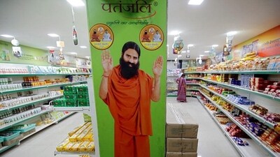 A hoarding with an image of Baba Ramdev inside a Patanjali store in Ahmedabad. (Reuters) A hoarding with an image of Baba Ramdev inside a Patanjali store in Ahmedabad. (Reuters)