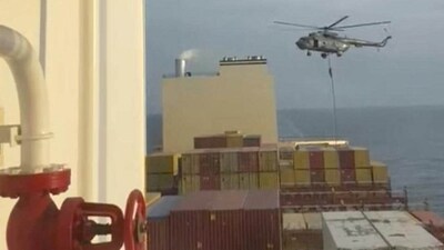 An official slides down a rope during a helicopter raid on MSC Aries ship at sea in this screen grab obtained from a social media video released on April 13 (via REUTERS) An official slides down a rope during a helicopter raid on MSC Aries ship at sea in this screen grab obtained from a social media video released on April 13 (via REUTERS)