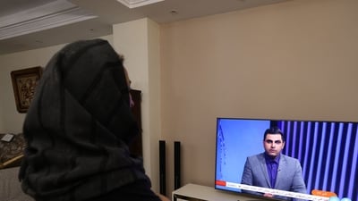 An Iranian woman watches an Iranian news TV channel, which is covering the news of Iran's attack on Israel, on April 14, 2024. Israel was coming under direct attack from Iran Saturday, the army announced, in a major escalation of the long-running covert war between the regional foes that threatened to overshadow the conflict in Gaza. (Photo by ATTA KENARE / AFP) An Iranian woman watches an Iranian news TV channel, which is covering the news of Iran's attack on Israel, on April 14, 2024. Israel was coming under direct attack from Iran Saturday, the army announced, in a major escalation of the long-running covert war between the regional foes that threatened to overshadow the conflict in Gaza. (Photo by ATTA KENARE / AFP)