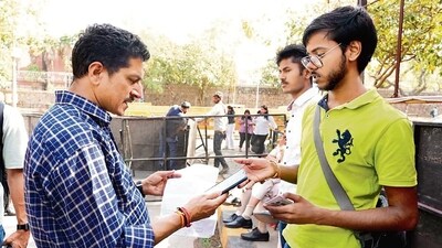 A professor checks the QR code generated for a student participant at Maitreyi College's fest, Rhapsody '24. A professor checks the QR code generated for a student participant at Maitreyi College's fest, Rhapsody '24.