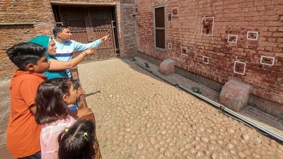 Visitors look at a wall with bullet marks during their visit to the Jallianwala Bagh Martyrs' Memorial on the eve of the Jallianwala Bagh massacre anniversary, in Amritsar (PTI) Visitors look at a wall with bullet marks during their visit to the Jallianwala Bagh Martyrs' Memorial on the eve of the Jallianwala Bagh massacre anniversary, in Amritsar (PTI)