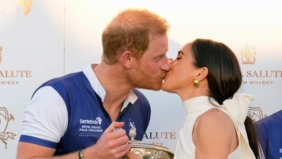 Britain's Prince Harry, left, and wife, Meghan Markle, Duchess of Sussex, kiss as she presents his polo team with the trophy for winning the Royal Salute Polo Challenge to Benefit Sentebale, Friday, April 12, 2024, in Wellington, Fla. Prince Harry, co-founding patron of the Sentebale charity, will play on the Royal Salute Sentebale Team. (AP Photo/Rebecca Blackwell) (AP) Britain's Prince Harry, left, and wife, Meghan Markle, Duchess of Sussex, kiss as she presents his polo team with the trophy for winning the Royal Salute Polo Challenge to Benefit Sentebale, Friday, April 12, 2024, in Wellington, Fla. Prince Harry, co-founding patron of the Sentebale charity, will play on the Royal Salute Sentebale Team. (AP Photo/Rebecca Blackwell) (AP)