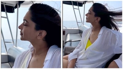Ranveer loves to click pictures and shoot videos of his gorgeous wife. This photo shows her in a yellow swimsuit and white shirt, enjoying the sea breeze on a yacht. Ranveer loves to click pictures and shoot videos of his gorgeous wife. This photo shows her in a yellow swimsuit and white shirt, enjoying the sea breeze on a yacht. 