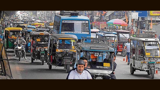 Commuters stuck in a traffic jam outside the railway station in Ludhiana on Saturday. (Manish/HT Photo)