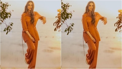 Her outfit, from the shelves of clothing brand Sonam Parmar Jhawar, is a long orange shirt with folded sleeves, a collar and a tie-up pattern on the side. She teamed it with a pair of loose-fitting matching trousers that complemented her top perfectly. (Instagram/@aditiraohydari)