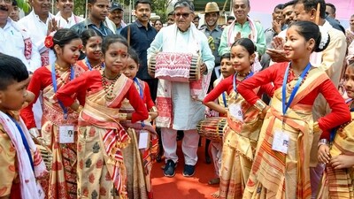 Assam Governor Gulab Chand Kataria plays traditional Assamese Dhol (drum) as children dressed up in traditional attire perform Bihu dance during Rongali Bihu celebration, at Kharguli in Guwahati on Saturday. (ANI) Assam Governor Gulab Chand Kataria plays traditional Assamese Dhol (drum) as children dressed up in traditional attire perform Bihu dance during Rongali Bihu celebration, at Kharguli in Guwahati on Saturday. (ANI)