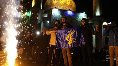 Iranians celebrate on a street, after the IRGC attack on Israel, in Tehran, Iran, April 14, 2024. Majid Asgaripour/WANA (West Asia News Agency) via REUTERS ATTENTION EDITORS - THIS IMAGE HAS BEEN SUPPLIED BY A THIRD PARTY (via REUTERS)