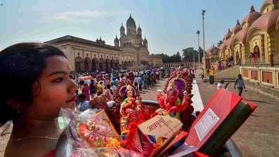 Devotees stand in a queue to offer prayers at Dakshineswar Kali Temple on Bengali New Year, in Kolkata on Sunday. (PTI) Devotees stand in a queue to offer prayers at Dakshineswar Kali Temple on Bengali New Year, in Kolkata on Sunday. (PTI)