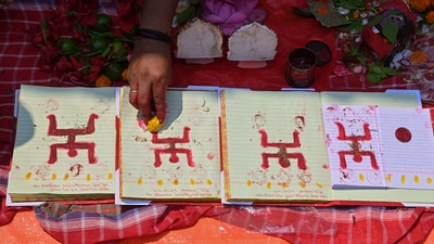 A priest worships thaders' ledger book on the occasion of Bengali New Year, 'Poila Baishakh', at the historic Kalighat Kali temple, in Kolkata on Sunday. (PTI) A priest worships thaders' ledger book on the occasion of Bengali New Year, 'Poila Baishakh', at the historic Kalighat Kali temple, in Kolkata on Sunday. (PTI)