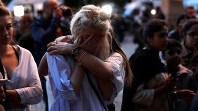 Women react after lighting candles for the victims of the Manchester Arena attack, in central Manchester, May 23. (Reuters Photo/File) Women react after lighting candles for the victims of the Manchester Arena attack, in central Manchester, May 23. (Reuters Photo/File)