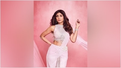 Shilpa's statement pre-draped chiffon saree features pearl and sequin embellishments on the waist, sheer pleats on the front adorned with sequinned embellishments, a pallu draped on the shoulder, and a figure-hugging silhouette. She wore the saree with a matching halter-neck sleeveless blouse featuring pearl tassels on the cropped hem, beaded adornments, and sequins. (Instagram) Shilpa's statement pre-draped chiffon saree features pearl and sequin embellishments on the waist, sheer pleats on the front adorned with sequinned embellishments, a pallu draped on the shoulder, and a figure-hugging silhouette. She wore the saree with a matching halter-neck sleeveless blouse featuring pearl tassels on the cropped hem, beaded adornments, and sequins. (Instagram)