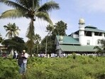 Two Muslim men greet each other after offering Eid prayers at a mosque on the flood affected island of Kunjunnikkara, outskirts of Kochi in the southern state of Kerala, India, Wednesday, Aug. 22, 2018.
