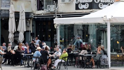 Israelis sit in a coffee shop in the Israeli coastal city of Netanya, on April 14, 2024. Iran launched its first-ever direct attack on Israeli territory late on APril 13, marking a major escalation of the long-running covert war between the regional foes and sparking fears of a broader conflict breaking out. (Photo by JACK GUEZ / AFP) (AFP) Israelis sit in a coffee shop in the Israeli coastal city of Netanya, on April 14, 2024. Iran launched its first-ever direct attack on Israeli territory late on APril 13, marking a major escalation of the long-running covert war between the regional foes and sparking fears of a broader conflict breaking out. (Photo by JACK GUEZ / AFP) (AFP)