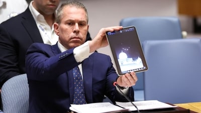 Israeli ambassador to the UN Gilad Erdan shows a video of drones and missiles heading toward Israel during a United Nations Security Council meeting on the situation in the Middle East, including Iran's recent attack against Israel in New York City on April 14. (AFP)