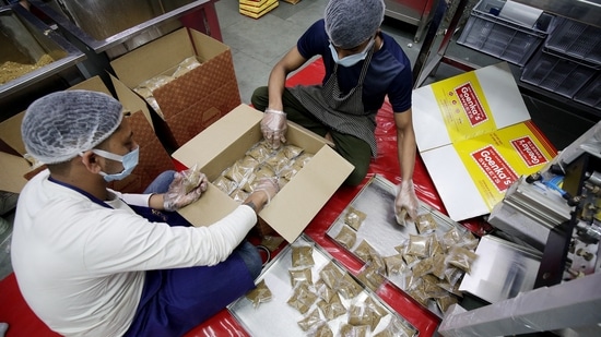 Workers pack the packets of the Prasad to be sent to Shri Ram Janmabhoomi Mandir in Ayodhya by the Durgiana Mandir management for the upcoming Ram Navami festival in Amritsar.(ANI)