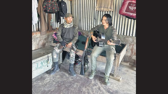 Inside the KNA camp, self-styled corporals Chungkholen (left) and Bosco singing a hymn. (Prawesh Lama/HT Photo)