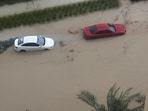 Cars are parked at a flooded street during a rain storm in Dubai, United Arab Emirates.