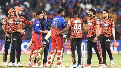 Royal Challengers Bengaluru's players exchange handshakes with other players after losing the match against Sunrisers Hyderabad by 25 runs (ANI  )