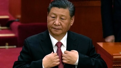 Chinese President Xi Jinping adjusts his jacket during the closing session of the National People's Congress held at the Great Hall of the People in Beijing. (AP) Chinese President Xi Jinping adjusts his jacket during the closing session of the National People's Congress held at the Great Hall of the People in Beijing. (AP)