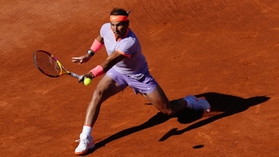 Spain's Rafael Nadal returns the ball to Italy's Flavio Cobolli during the ATP Barcelona Open "Conde de Godo" tennis tournament singles match at the Real Club de Tenis in Barcelona, (AFP)