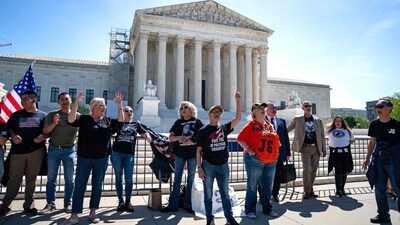 WASHINGTON, DC - APRIL 16: Supporters of January 6 defendants including Micki Witthoeft, the mother of Ashli Babbitt, who was killed on January 6, 2021, sing "God Boss the USA" outside of the Supreme Court on April 16, 2024 in Washington, DC. The Supreme Court is hearing oral arguments in Fischer v. U.S., a case about whether the U.S. Court of Appeals for the District of Columbia Circuit erred in applying a specific part of U.S. criminal code when charging January 6 defendants. Kent Nishimura/Getty Images/AFP (Photo by Kent Nishimura / GETTY IMAGES NORTH AMERICA / Getty Images via AFP) (Getty Images via AFP) WASHINGTON, DC - APRIL 16: Supporters of January 6 defendants including Micki Witthoeft, the mother of Ashli Babbitt, who was killed on January 6, 2021, sing "God Boss the USA" outside of the Supreme Court on April 16, 2024 in Washington, DC. The Supreme Court is hearing oral arguments in Fischer v. U.S., a case about whether the U.S. Court of Appeals for the District of Columbia Circuit erred in applying a specific part of U.S. criminal code when charging January 6 defendants. Kent Nishimura/Getty Images/AFP (Photo by Kent Nishimura / GETTY IMAGES NORTH AMERICA / Getty Images via AFP) (Getty Images via AFP)