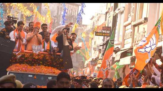 Chief minister Yogi Adityanath holds a roadshow in Saharanpur on Tuesday. (ht photo)