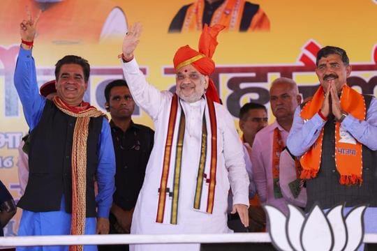 Union home minister Amit Shah flanked by J&K BJP president Ravinder Raina and party candidate Jugal Kishore Sharma at the rally in Jammu on Tuesday. (PTI Photo) Union home minister Amit Shah flanked by J&K BJP president Ravinder Raina and party candidate Jugal Kishore Sharma at the rally in Jammu on Tuesday. (PTI Photo)