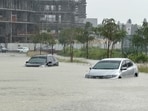 Cars drive through a flooded street during a rain storm in Dubai, United Arab Emirates, April 16, 2024.