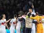 Paris Saint-Germain's French forward #07 Kylian Mbappe (Top) and teammates celebrate after winning the UEFA Champions League quarter-final second leg against FC Barcelona