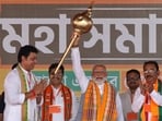 Prime Minister Narendra Modi holds up a mace during an election campaign rally in Agartala. (Reuters)
