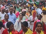 Trinamool Congress leader Mamata Banerjee, center, greets as she walks with tribal people during an election campaign rally in Siliguri, on Tuesday. (AP Photo/Diptendu Dutta)(AP)
