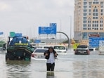 A driver walks along a flooded highway after a rainstorm in Dubai, United Arab Emirates, on Wednesday A driver walks along a flooded highway after a rainstorm in Dubai, United Arab Emirates, on Wednesday