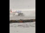 Dubai rain: The image shows a flight on a waterlogged tarmac at Dubai Airport. Dubai rain: The image shows a flight on a waterlogged tarmac at Dubai Airport.