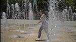 A Cuban tourist cools off at a water fountain in the Monumento a la Revolucion square during a heat wave that hit Mexico City on Tuesday. (AFP)
