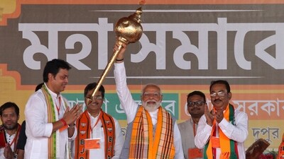 Prime Minister Narendra Modi holds up a mace during an election campaign rally in Agartala. (Reuters)