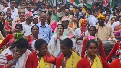 Trinamool Congress leader Mamata Banerjee, center, greets as she walks with tribal people during an election campaign rally in Siliguri, on Tuesday. (AP Photo/Diptendu Dutta) (AP) Trinamool Congress leader Mamata Banerjee, center, greets as she walks with tribal people during an election campaign rally in Siliguri, on Tuesday. (AP Photo/Diptendu Dutta) (AP)