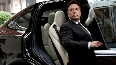 Tesla Chief Executive Officer Elon Musk gets in a Tesla car as he leaves a hotel in Beijing, China. (Reuters)