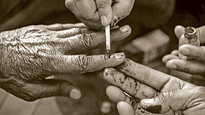 An election official marks the finger of a senior citizen with indelible ink in Bikaner, Rajasthan. (PTI Photo) An election official marks the finger of a senior citizen with indelible ink in Bikaner, Rajasthan. (PTI Photo)