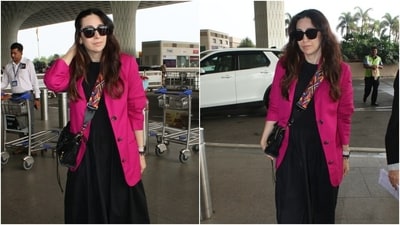 Karisma Kapoor in a midi dress, hot pink blazer and a no-makeup look poses for the paparazzi at the airport. (HT Photo/Varinder Chawla) Karisma Kapoor in a midi dress, hot pink blazer and a no-makeup look poses for the paparazzi at the airport. (HT Photo/Varinder Chawla)