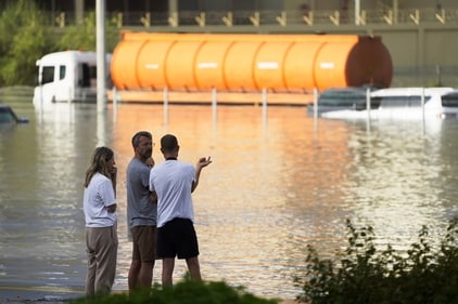 People look out at floodwater covering a major road in Dubai, United Arab Emirates, Wednesday, April 17, 2024. (AP) People look out at floodwater covering a major road in Dubai, United Arab Emirates, Wednesday, April 17, 2024. (AP)