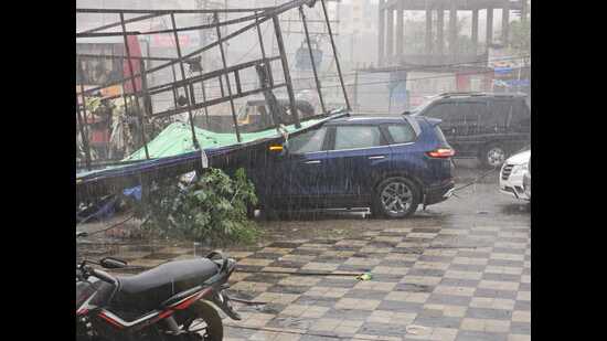 Due to the rain, a hoarding fell near a bus stop in Ubale Nagar near Kharadi, damaging a vehicle in the bargain. (HT PHOTO)