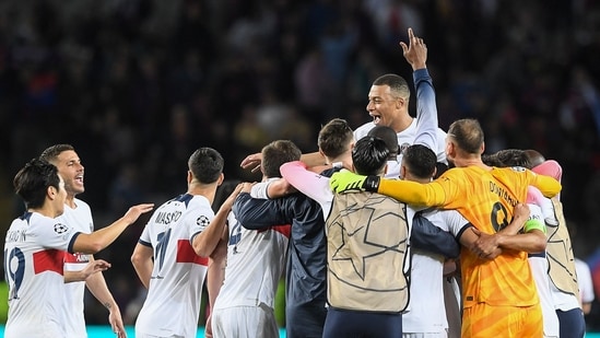 Paris Saint-Germain's French forward #07 Kylian Mbappe (Top) and teammates celebrate after winning the UEFA Champions League quarter-final second leg against FC Barcelona (AFP)
